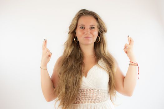 Pretty blonde girl in a white dress very happy