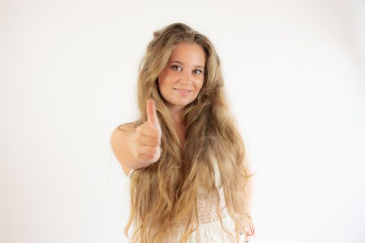 Pretty blonde girl in a white dress making finger up gesture