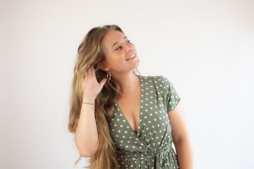 Beautiful young girl with long hair making the listening gesture