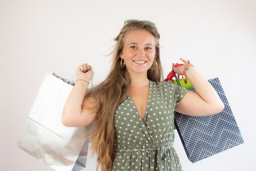 Beautiful young girl shopping with bags in hand