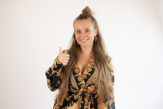 Pretty blonde girl in black gold dress smiling