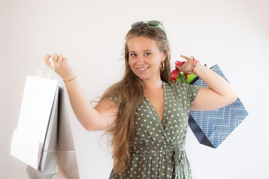 Beautiful young girl shopping with bags in hand