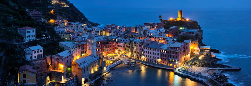 View of Vernazza village popular tourist destination in Cinque Terre National Park a UNESCO World Heritage Site, Liguria, Italy view illuminated in the night from Azure trail