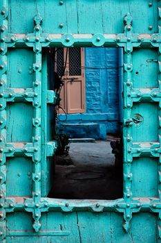 Old wooden door in blue houses of Jodhpur, Rajasthan, India