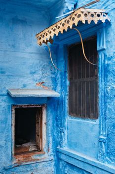 Windows in blue house facade in streets of of Jodhpur, also known as Blue City due to the vivid blue-painted Brahmin houses, Jodhpur, Rajasthan, India