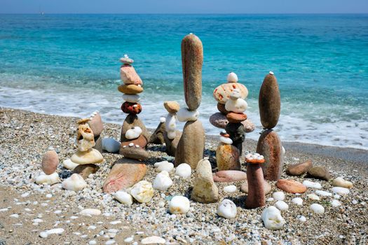 Concept of zen balance relaxation peace and harmony. Pebbles stacks on the beach coast of the blue sea in the nature. Meditative art of stone stacking.