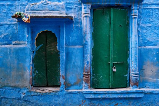 Blue house facade in streets of of Jodhpur, also known as Blue City due to the vivid blue-painted Brahmin houses, Jodhpur, Rajasthan, India