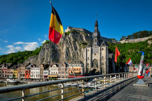 Picturesque Dinant town, Dinant Citadel and Collegiate Church of Notre Dame de Dinant and Charles de Gaulle bridge with saxophones as Dinant is hometown of saxophone inventor and flags. Namur, Blegium