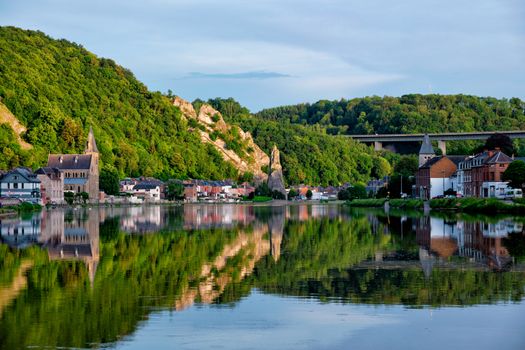 View of picturesque Dinant city over the Meuse river Dinant is a Walloon city and municipality located on the River Meuse, in the Belgian province of Namur on sunset with Bayard Rock and highway