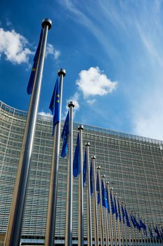 Helplessly drooping EU European Union flags with the European Comission building in Background. Brussles, Belgium