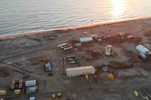 An oil field by the sea. service buildings and equipment.