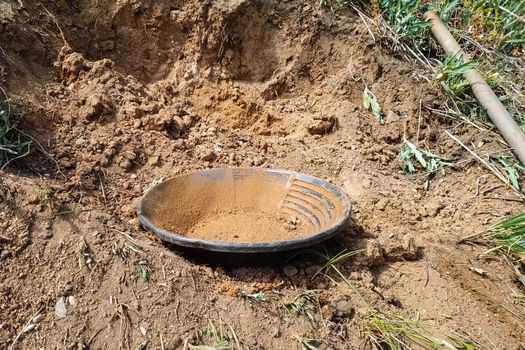 A plate for rinsing rock in search of gold.