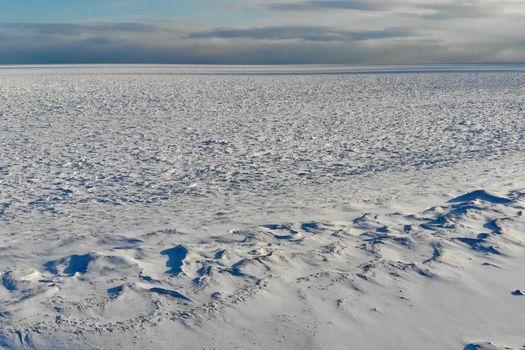 The shore of the arctic ocean. Snow and ice on the shore.