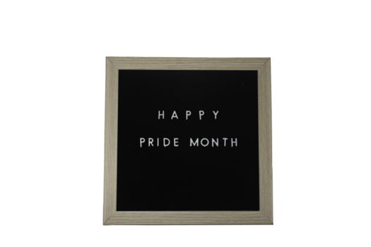 A Black Sign With a Birch Frame That Says Happy Pride Month in White Letters on a Pure White Background