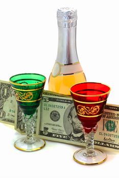 Wine-glasses wine and dollars on a white background