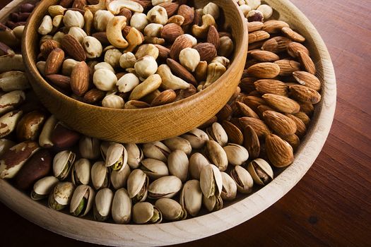 Set of various nuts in a wooden bowl