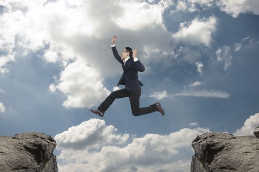 Asian Businessman  jump on blue sky,Business success concept