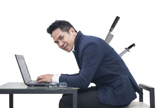 Portrait of young man sitting working on laptop  at his desk on white background,Persistence Concept. 
A man is working harder to achieve new sales target.