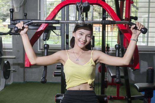 Portrait asian women  exercises are the shoulder and chest muscles at fitness club,Healthy concept