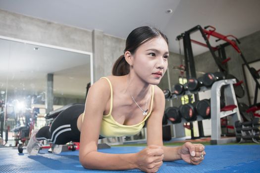  fit asian woman exercising by doing push-ups,Healthy concept