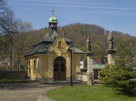 Small Baroque chapel at the entrance to areal of Basilica of the Visitation Virgin Mary in spring, Hejnice, Jizera mountain, Czech Republic.