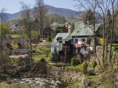 View on Village Hejnice with cottages and creek in spring, Hejnice, Jizera mountain, Czech Republic.