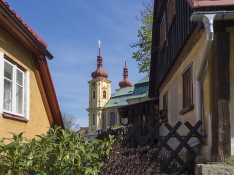 Village Hejnice with View on Baroque Basilica church of the Visitation Virgin Mary in spring, place of pilgrimage, Hejnice, Jizera mountain, Czech Republic.