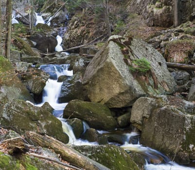 long exposure waterfal cascade in Jizerske hory, Jizera mountain, forest on Cerny Stolpich black creek in czech republic, green mossed stones, ferns and trees.
