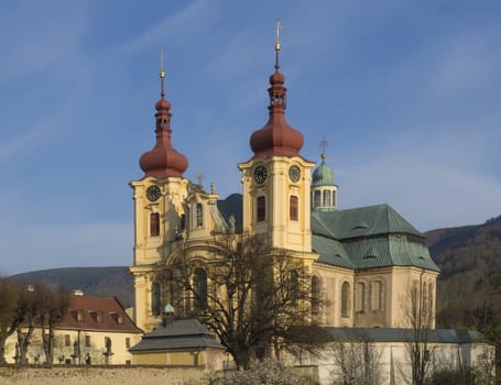 Baroque Basilica church of the Visitation Virgin Mary in spring, golden hour light, place of pilgrimage, Hejnice, Jizera mountain, Czech Republic.