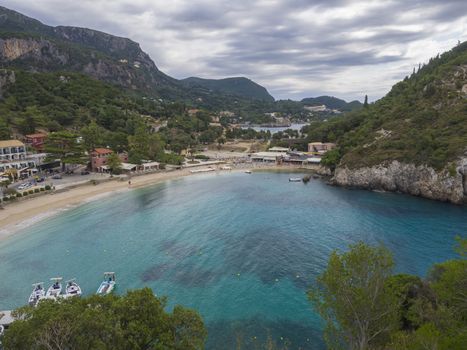 Beautiful Paleokastritsa bay with sand beach on Corfu, Kerkyra, Greece, moody sky, summer
