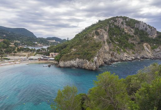 Beautiful Paleokastritsa bay with sand beach on Corfu, Kerkyra, Greece, moody sky, summer