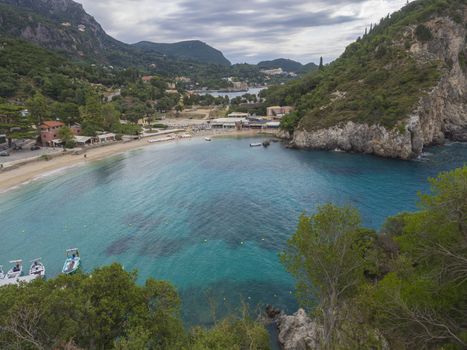 Beautiful Paleokastritsa bay with sand beach on Corfu, Kerkyra, Greece, moody sky, summer