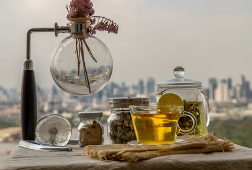 Refreshing and enjoy with A cup of lemongrass pandan tea served with brown sugar In the afternoon on beautiful city view. Thai herbal plant and healthy drinks concept. Selective focus, Copy space.