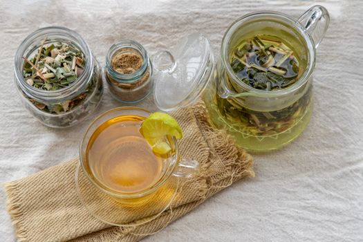 Refreshing and enjoy with A cup of lemongrass pandan tea served with brown sugar In the afternoon on white table. Thai herbal plant and healthy drinks concept. Top view, Selective focus, Copy space.