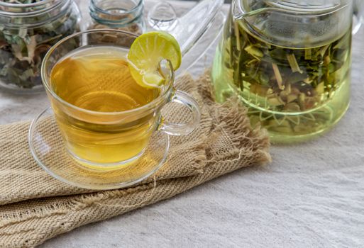 Refreshing and enjoy with A cup of lemongrass pandan tea served with brown sugar In the afternoon on white table. Thai herbal plant and healthy drinks concept. Top view, Selective focus, Copy space.