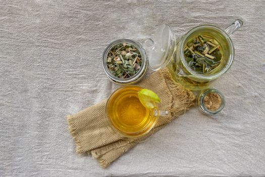 Refreshing and enjoy with A cup of lemongrass pandan tea served with brown sugar In the afternoon on white table. Thai herbal plant and healthy drinks concept. Top view, Selective focus, Copy space.