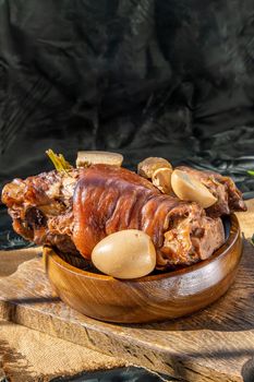 Chinese traditional dish stewed pork leg with boiling sweet gravy sauce and boiled egg with tofu. Selective focus.