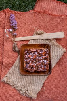 Traditional homemade sweet bread : Walnut toffee cake with caramel on beautiful background. One piece, Selective focus.