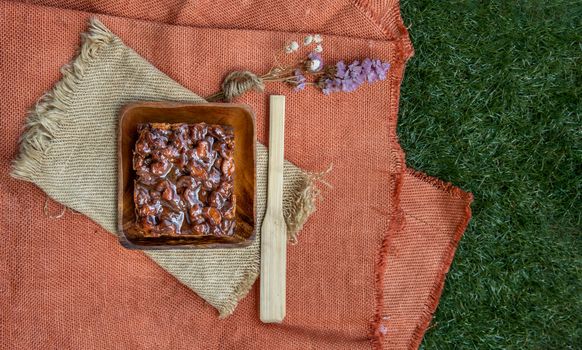 Traditional homemade sweet bread : Walnut toffee cake with caramel on beautiful background. One piece, Selective focus.