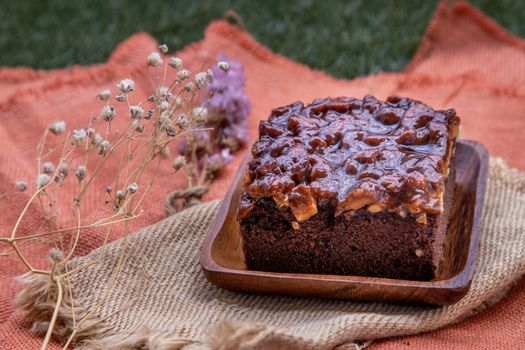 Traditional homemade sweet bread : Walnut toffee cake with caramel on beautiful background. One piece, Selective focus.