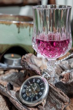 Grape juice with A retro pocket watch on wooden background. The concept of relaxing and reminiscing old memories.