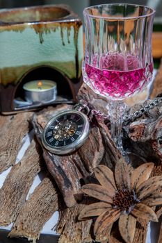 Grape juice with A retro pocket watch on wooden background. The concept of relaxing and reminiscing old memories.