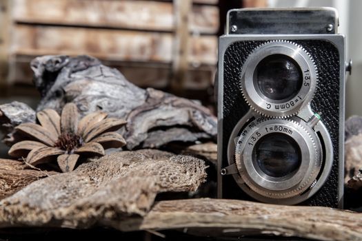 Vintage two lens photo camera on wooden background. An idea of old camera and memory, time Nostalgia.