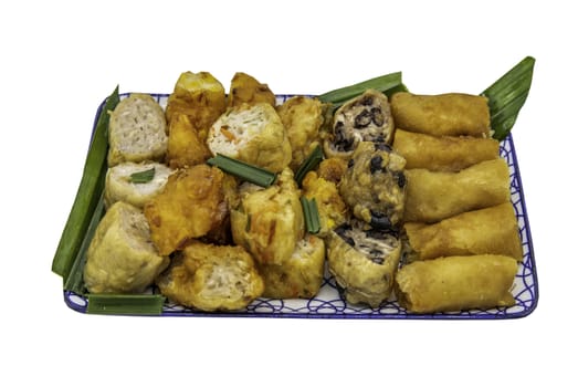 Many vegetarian food : Fried taro rolls (Taro Guangjian) and Deep fried spring rolls, Fried tofu, Fried radish, Fried taro and black beans (Zhu jiao quan or Fried taro cakes) isolated on white background with clipping path. Selective focus.