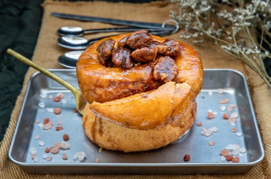 Traditional French sweet dessert : Pecan peanut Brioche on the silver tray. Delicious seasonal breakfast, Oblique view from the top. Selective focus.