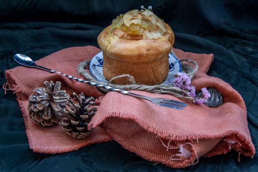 Traditional French sweet dessert : Apple Brioche on beautiful background. One piece. Delicious seasonal breakfast. Oblique view from the top, Selective focus.