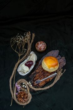 Traditional french sweet dessert : Scones on the wooden tray served with Homemade raspberry jam and Mascarpone cheese on Shell. Delicious seasonal breakfast. Selective focus.