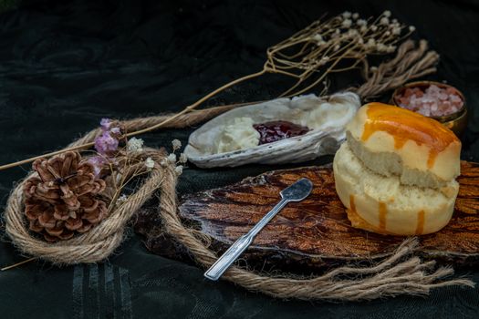 Traditional french sweet dessert : Scones on the wooden tray served with Homemade raspberry jam and Mascarpone cheese on Shell. Delicious seasonal breakfast. Selective focus.