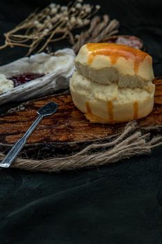 Traditional french sweet dessert : Scones on the wooden tray served with Homemade raspberry jam and Mascarpone cheese on Shell. Delicious seasonal breakfast. Selective focus.