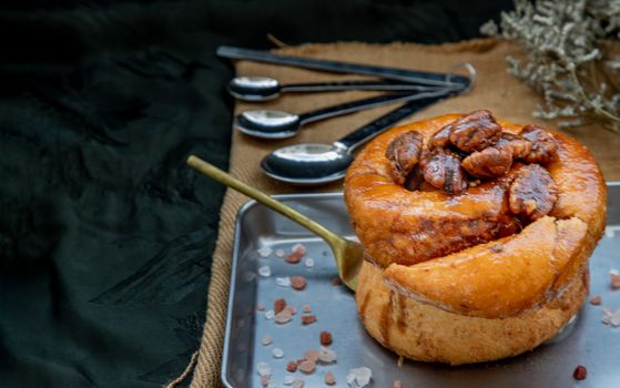 Traditional French sweet dessert : Pecan peanut Brioche on the silver tray. Delicious seasonal breakfast, Oblique view from the top. Selective focus.